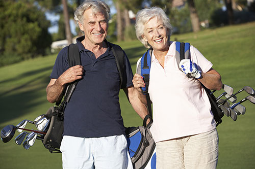 Senior man and women playing golf