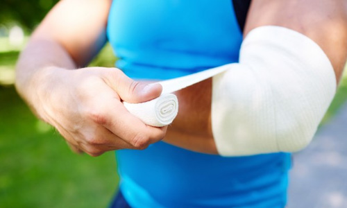 a man with a wrap bandage on his elbow